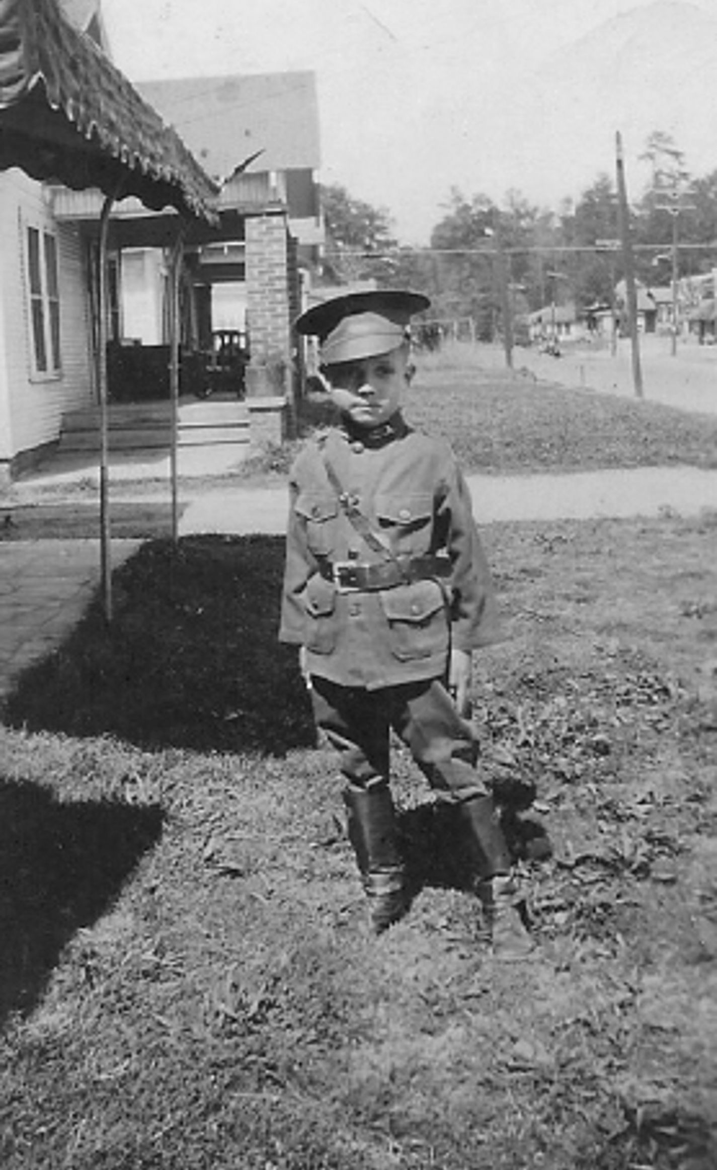 Mack poses as a child in a uniform